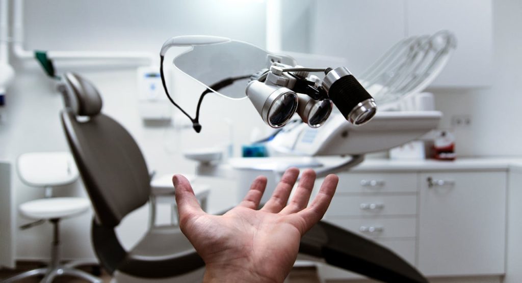 Floating dental loupes in a modern, clean dentist office setting.